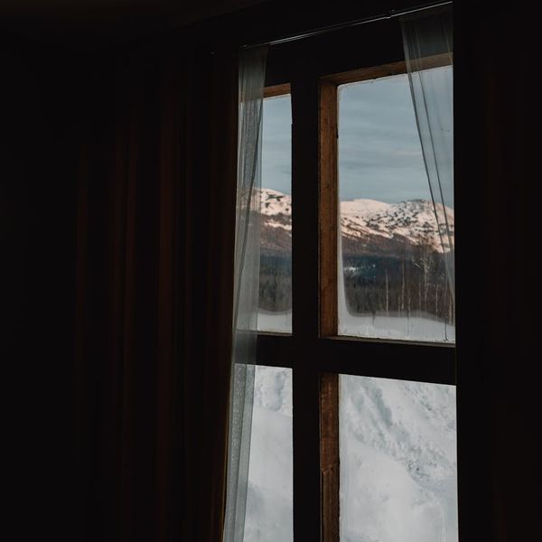 Smiling person stretching outdoors at sunrise, feeling energized and happy.